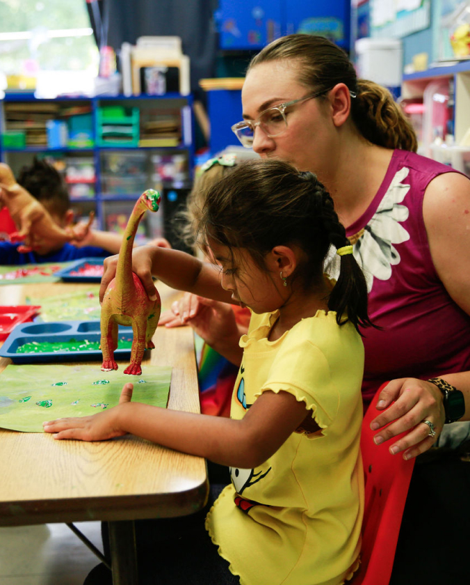 Kids learning how to paint with teacher